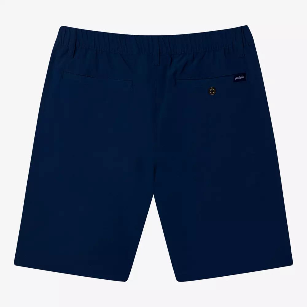 Navy blue shorts shown from the back, featuring two rear pockets—one with a button closure and a small label above it. With an elastic waistband and clean design, they pair well with the best golf travel bags for effortless style on the go.