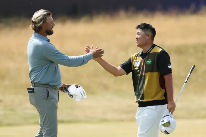 Daniel Brown of England and Sungjae Im of South Korea shake hands after finishing their round on the 18th green on day one of the The 154th Open Championship at Royal Birkdale on July 16, 2026 in Southport, England.