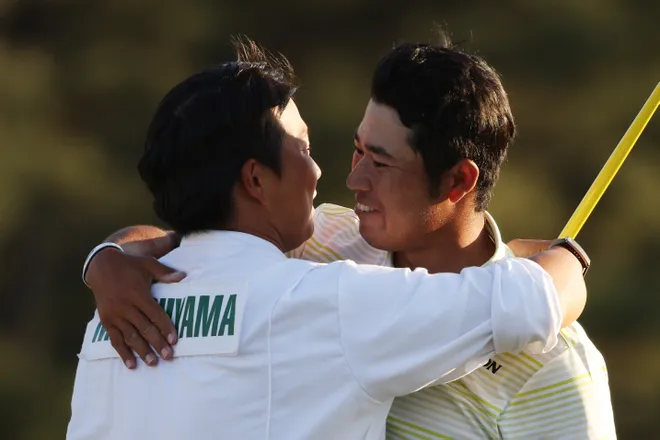 Hideki Matsuyama of Japan hugs his caddie, Shota Hayafuji, on the 18th green after winning the Masters at Augusta National Golf Club on April 11, 2021 in Augusta, Georgia.