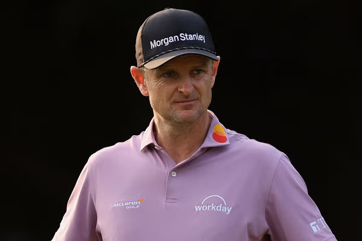 Justin Rose looks on