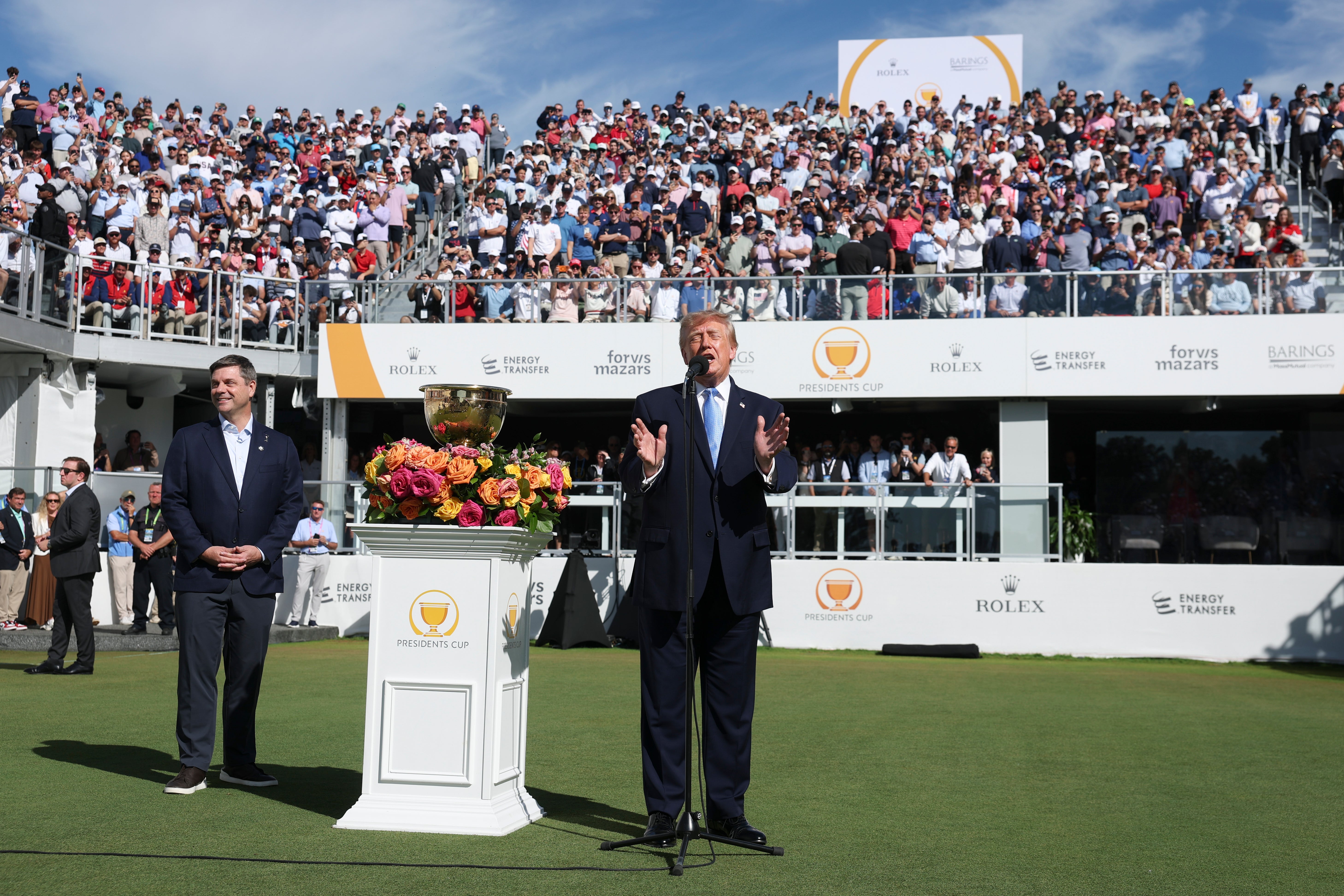 U.S. President Donald Trump speaks as CEO of PGA Tour Brian Rolapp looks on
