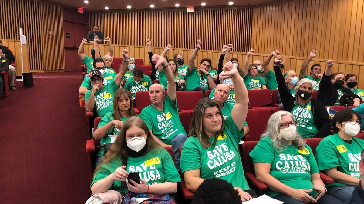 Residents wore green “Save Calusa” T-shirts to a county meeting about the proposed development in 2021.
