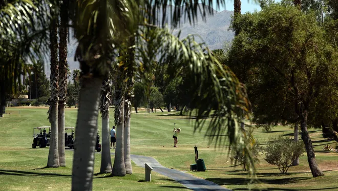 A golfer tees off at Desert Princess Country Club in Cathedral City. The golf course has made significant progress in removing grass and converting to desert landscaping. Water districts' records show, however, that Coachella Valley golf courses as a whole have fallen short of California's conservation goals during the past year.