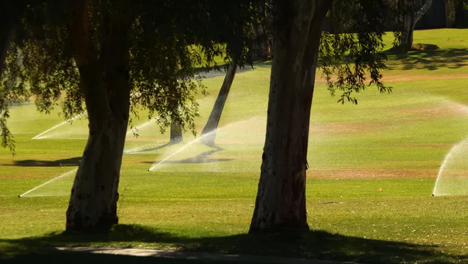 Sprinklers water one of the 121 golf courses in the Coachella Valley.