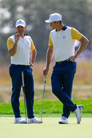 Sep 26, 2025; Bethpage, New York, USA; Rory McIlroy and Justin Rose discuss the put on the tenth hole during the practice round on the first day of competition for the Ryder Cup at Bethpage Black. Mandatory Credit: Dennis Schneidler-Imagn Images