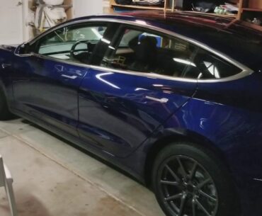 Tesla model 3 with golf clubs