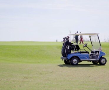 two golf carts loaded with bags and equipment