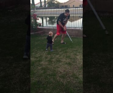 Baby enthralled with golf club
