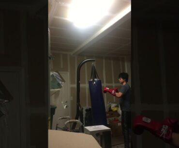 Beginner hitting the 100 lb. bag