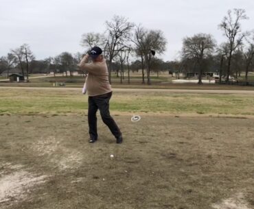 One handed golfer tees off