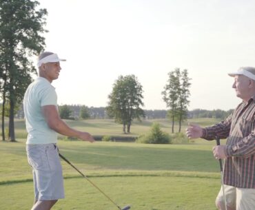 confident middle eastern golfer swinging and hitting golf ball on beautiful course an ol