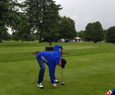 Jim Kelly tees of at his annual charity golf tournament