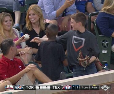 Young fan gives decoy ball to pretty lady