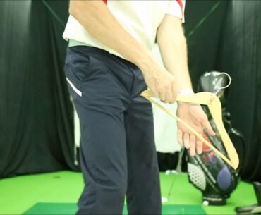 The coat hanger drill for a correct golf grip