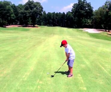 Noah hitting a hybrid in the fairway