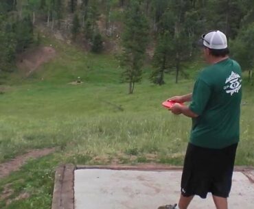 Disc Golf - Doug S. putter drive on Hole 16 at Beaver Ranch in Conifer, CO