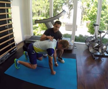 Ian Poulter with his trainer doing knee suspension exercises.