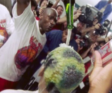 Michael Jordan-''That's a waterproof color'' as he pours champagne over Rodman's hair