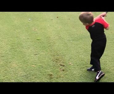 Kids golfing - Showing dad how to use a six iron