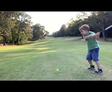 Kids - golfing Wesley hits a net set up in the fairway with his driver