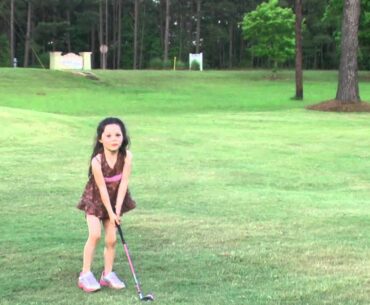 Four Year Old Girl Playing Golf and Having Fun