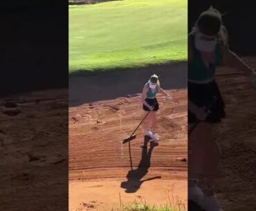 Grace Charis raking sand pitts