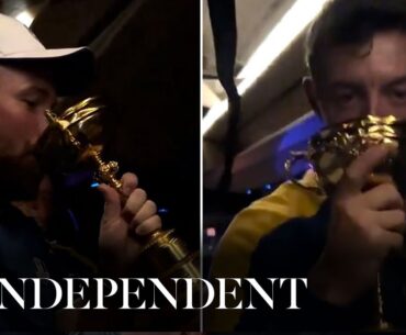 Rory McIlroy and Shane Lowry drink from Ryder Cup trophy