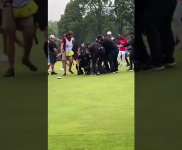Security gaurd tackles golfer Adam Hadwin while he was trying to celebrate with winner Nick Taylor.