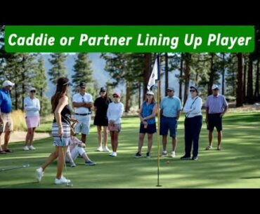 Can a caddie line up a player on the putting green?