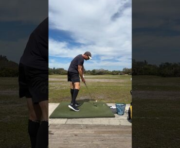 At the driving range practicing my golf swing.