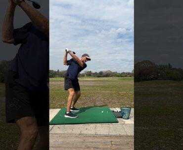 Practicing my golf swing with a fairway wood.