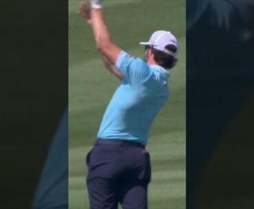 Adam Hadwin discards his club in the lake after finding water on 18