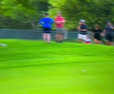 Jordan Spieth's drive hits a spectator's elbow, ricochets into fairway.