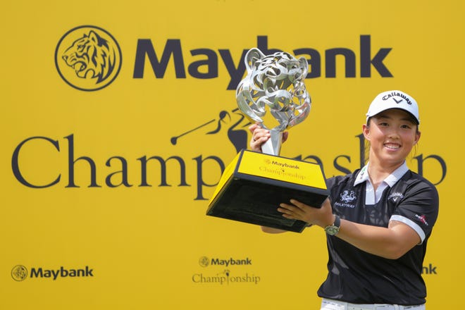 Yin Ruoning of China poses with the trophy during the awards ceremony after winning the LPGA Tour's Maybank Championship at Kuala Lumpur Golf and Country club in Kuala Lumpur, Sunday, Oct. 27, 2024.