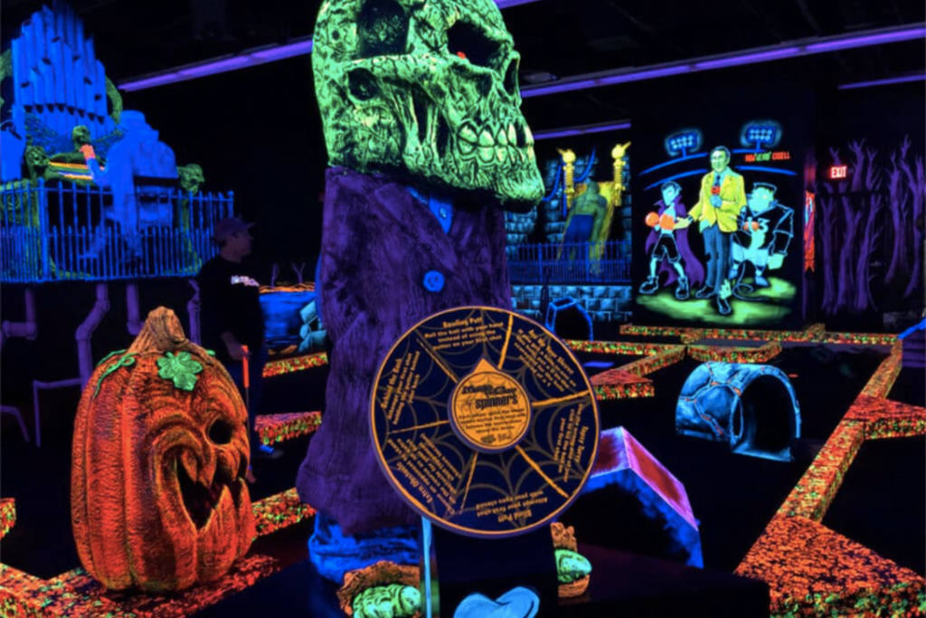 Image shows the glow-in-the-dark mini-golf course at Monster Mini-Golf in Houston. 