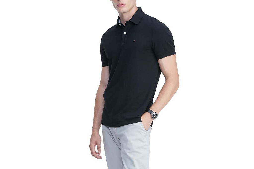 A man in a black shirt playing golf
