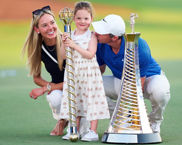 Pedro Salado/Getty Rory McIlroy of Northern Ireland poses with his Wife, Erica Stoll and daughter, Poppy McIlroy alongside the DP World Tour Championship trophy
