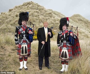 US President elect Donald Trump (C) poses with Scottish pipers during a visit to the construction site of his golf course on the Menie Estate near Aberdeen