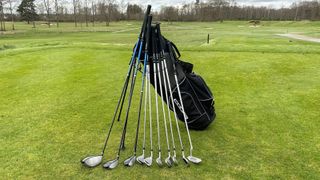 The Cobra Fly XL Package Set with every club resting on the golf bag, on a tee box