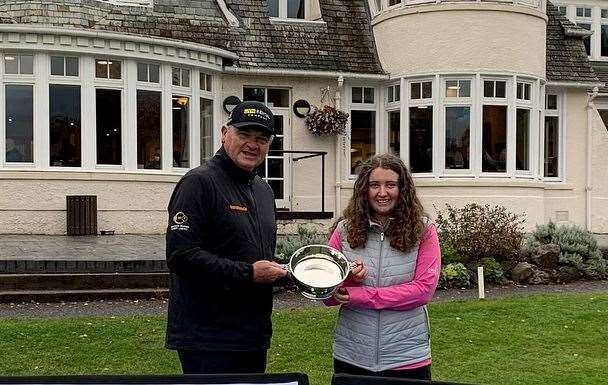 Kaci Robertson receives the quaich from Paul Lawrie after her victory in Blairgowrie.