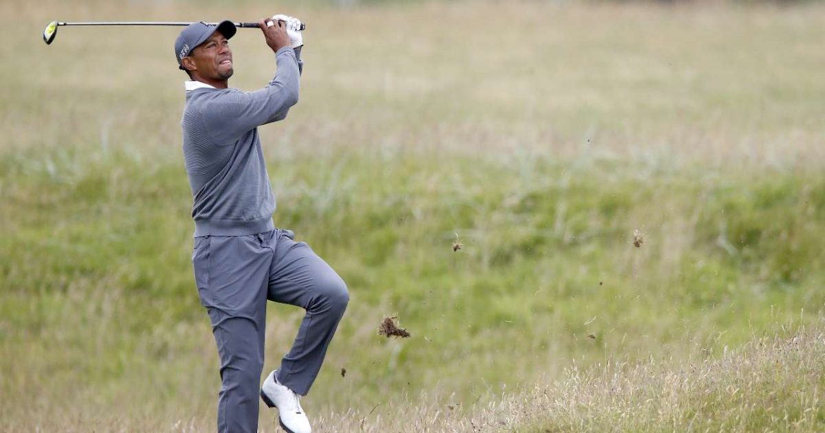 Tiger Woods plays from the rough