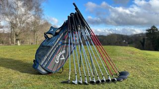 The Callaway XR package set golf clubs and bag laid out on grass