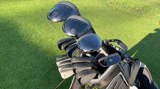 A close-up of the black golf clubs in the Stix Complete Set