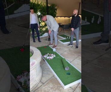 wedding guests playing wedding mini golf at wedding drinks reception. Wedding crazy golf