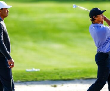 Tiger Woods, left, watches son Charlie practice ahead of the weekend