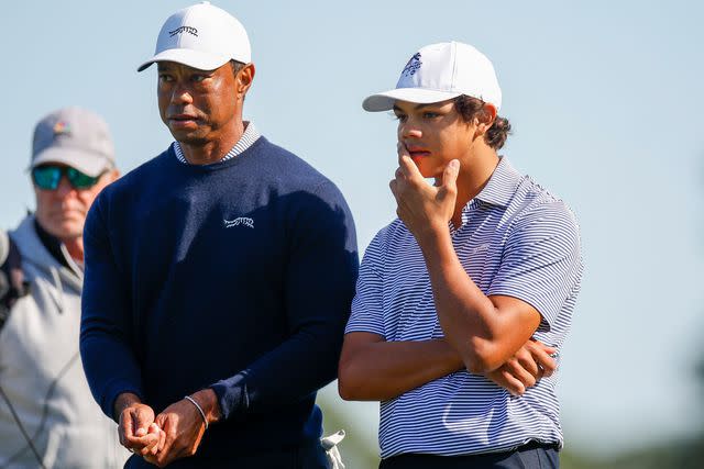 Mike Ehrmann/Getty Tiger Woods and son Charlie talk during the second hole at the first round of the PNC Championship at the Ritz-Carlton Golf Club on Dec. 21, 2024