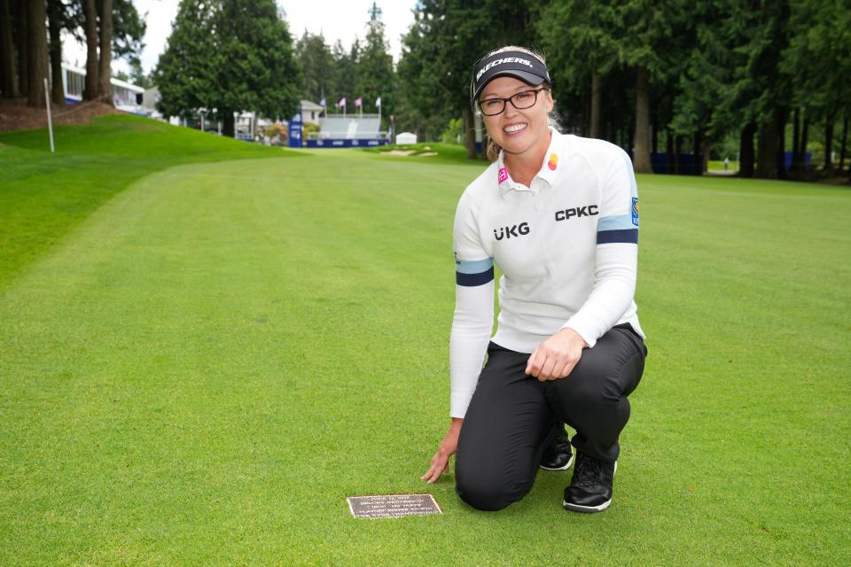 Brooke Henderson poses with her plaque on the 18th hole fairway during the 2024 KPMG Women's PGA Championship at Sahalee Country Club. (Darren Carroll/PGA of America)