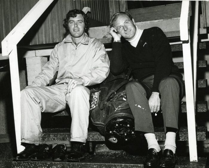 Bernard Gallacher and Ronnie Shade sit on some steps after the completion of their day's golf. 