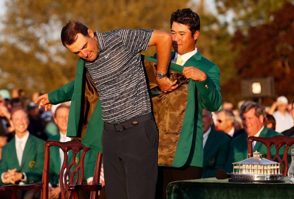 Hideki Matsuyama (right) helps Scottie Scheffler put on the Green Jacket at the 2022 Masters. Photo: EPA-EFE