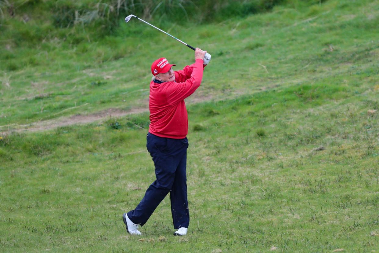 Former U.S. President and Republican presidential candidate Donald Trump plays golf at Trump International Golf Links